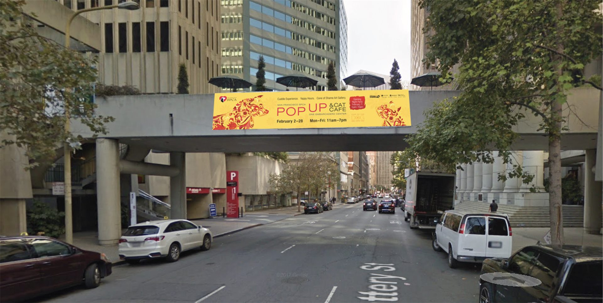 San Francisco SPCA Cuddle Experience banner over a downtown street